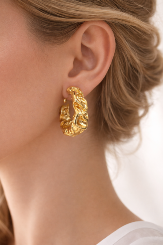 Elegant gold sculptural hoop earring